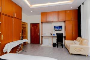 a hospital room with a bed and a desk and cabinets at One Click Cozy Suites in Kigali