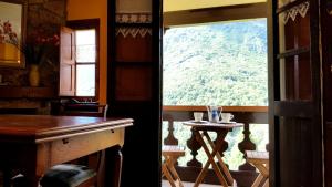 a view from a room with a table and a window at La Casina de Toñita in Cazo