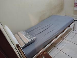 a small hospital bed with a pillow on it at Casa temporada soares in São José da Barra