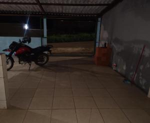 a motorcycle parked in a garage at night at Casa temporada soares in São José da Barra