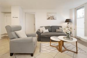 a living room with a couch and a table at Haus Strandgeflüster Sandbank in Grömitz