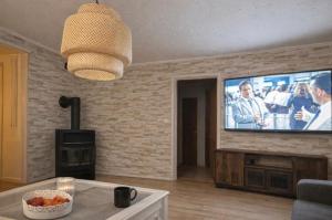 a living room with a tv on a brick wall at Little Sven#s House in Mellansel
