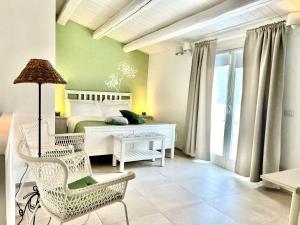 a bedroom with a bed and a table and chairs at Giardino Botanico in Ragusa
