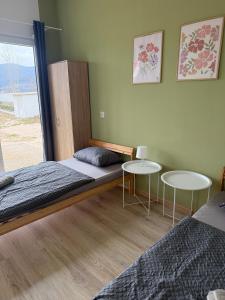 a bedroom with two beds and two tables at Sunny Resort in Donji Karin +20 photos