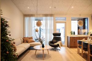 a living room with a christmas tree and a couch at Villa Memory-Aurora view bath-Sauna-Lapland-Santa in Rovaniemi