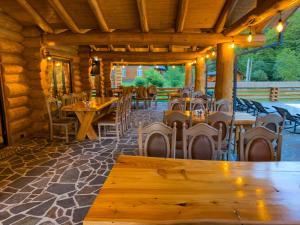a dining room with wooden tables and chairs at Barlogul Ursului in Baia Mare