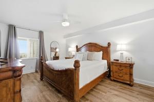 a bedroom with a bed and a dresser and a window at SeaSpray Riverside 712 in Perdido Key +39 photos