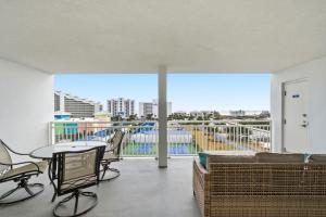 a living room with a balcony with a table and chairs at SeaSpray Riverside 712 in Perdido Key