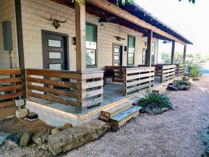 a porch of a house with a wooden fence at Lodge 2 on the Mason TX square in Mason