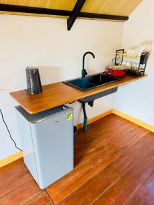 a kitchen with a sink and a counter top at Phayam Paradise Resort in Ko Phayam