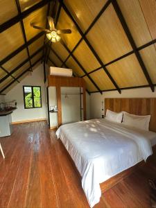 a bedroom with a white bed and a ceiling fan at Phayam Paradise Resort in Ko Phayam +62 photos
