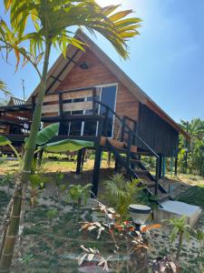 a house with a staircase leading up to it at Phayam Paradise Resort in Ko Phayam