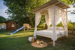 a canopy bed with a slide and a playground at Villa mit Pool und Garten in Thalheim bei Wels