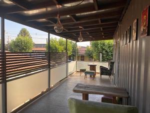 a patio with a wooden table and chairs on a balcony at Departamento Terraza in Molina