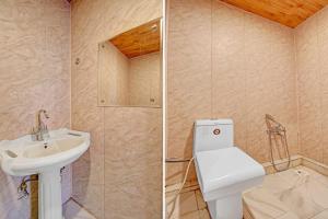 a bathroom with a toilet and a sink at Hotel Lake Side in Srinagar
