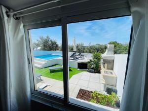 a window view of a pool from a house at Cantinho do Alandroal in Alandroal