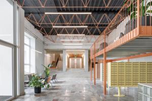 a hallway with stairs and benches in a building at Košice Kysucka Apartment in Košice +5 photos