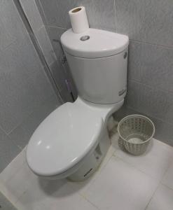 a toilet with a roll of toilet paper on top of it at La Chambre d hote in Ouarzazate