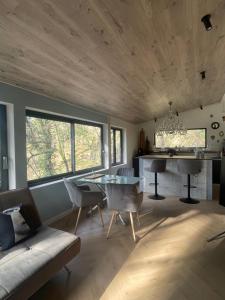 a living room with a couch and a table at La Noirie in Saint-Étienne
