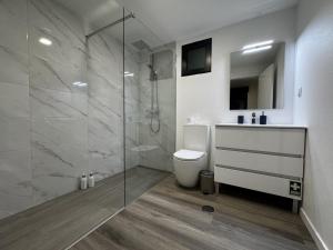 a bathroom with a shower and a toilet and a sink at Hiking & Ocean in Arco da Calheta