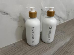 two white bottles sitting on top of a counter at Hiking & Ocean in Arco da Calheta +33 photos