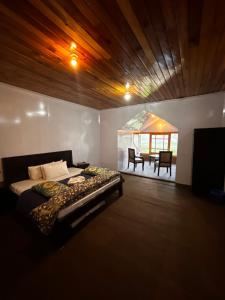 a bedroom with a bed and a living room with a table at Kehkashan in Shongran