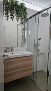 a bathroom with a sink and a shower at LAM Design Greenery AC - Balcony in Bratislava +19 photos
