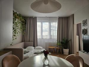 a living room with a couch and a table at LAM Design Greenery AC - Balcony in Bratislava