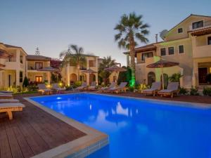a swimming pool in the middle of a villa at Ionian Coco Palm Beach Villas in Tsilivi