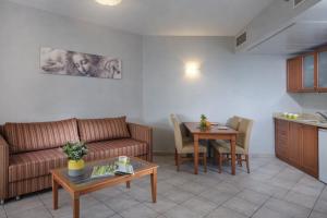 a living room with a couch and a table at חדר על הים בבת ים in Bat Yam