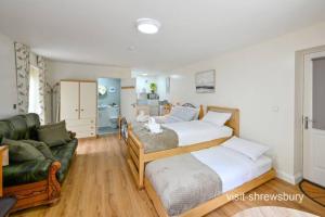 a bedroom with two beds and a couch at Personal En-suite in Shrewsbury