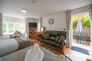 a bedroom with a bed and a couch at Personal En-suite in Shrewsbury