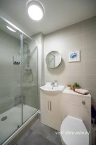 a bathroom with a shower and a toilet and a sink at Personal En-suite in Shrewsbury +7 photos