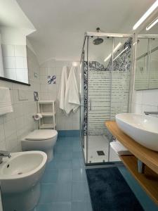 a bathroom with a sink and a toilet and a shower at Dimora Rosella in Tramonti