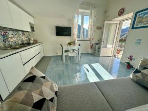 a kitchen and living room with a table and chairs at Dimora Rosella in Tramonti +31 photos
