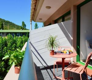 a balcony with a table and chairs and a fence at Sure Hotel by Best Western Gemenos en Provence in Gémenos