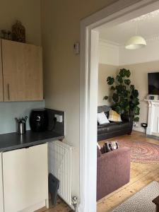 a living room with a couch and a table at A Wee Cottage In Dunfermline in Dunfermline