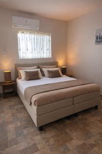 a large bed in a bedroom with a window at Apartments Diva Flamingo in Barber +6 photos