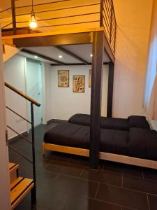 a bedroom with a bunk bed and a staircase at Officina dei ricordi in Casagiove