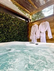two robes are hanging next to a hot tub at Danu 1A -Hot Tub-Perth-Pet Friendly-Luxury-Romantic in Perth