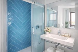 a bathroom with a sink and a glass shower at Sorrento life 3 in Sant'Agnello