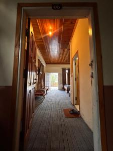 a hallway of a house with a wooden ceiling at Kehkashan in Shongran