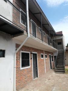a brick building with stairs and a balcony at Cozy apartment close to everything in Asunción