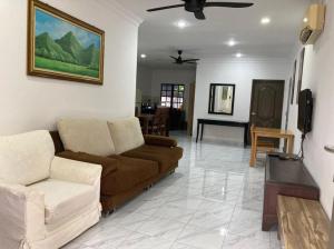 a living room with a couch and a table at Msy Residence in Shah Alam