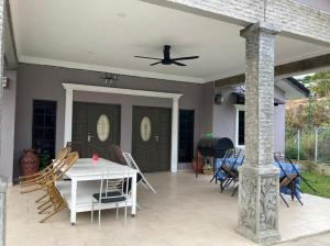 a patio with a table and chairs and a ceiling at Msy Residence in Shah Alam