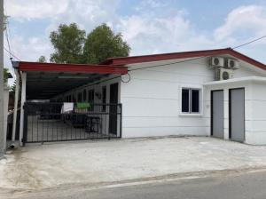 a white building with a gate and a garage at Msy Residence in Shah Alam