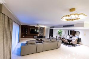 a living room with a couch and a table at Deluxe Ocean Apartment Heliopolis in Cairo