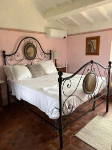 a bedroom with a bed with a metal frame at Villa Serena in Coreglia Antelminelli +33 photos