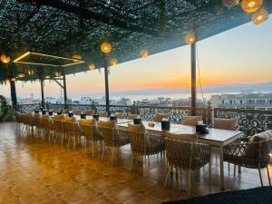 a restaurant with tables and chairs and a view at Grand Season Hotel in Aqaba