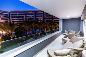 a balcony with a view of the city at night at Deluxe Ocean Apartment Heliopolis in Cairo